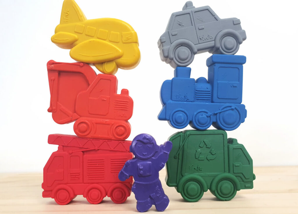 Original colour Toddler Transport set stacked with a standard-size astronaut crayon in the foreground to show scale
